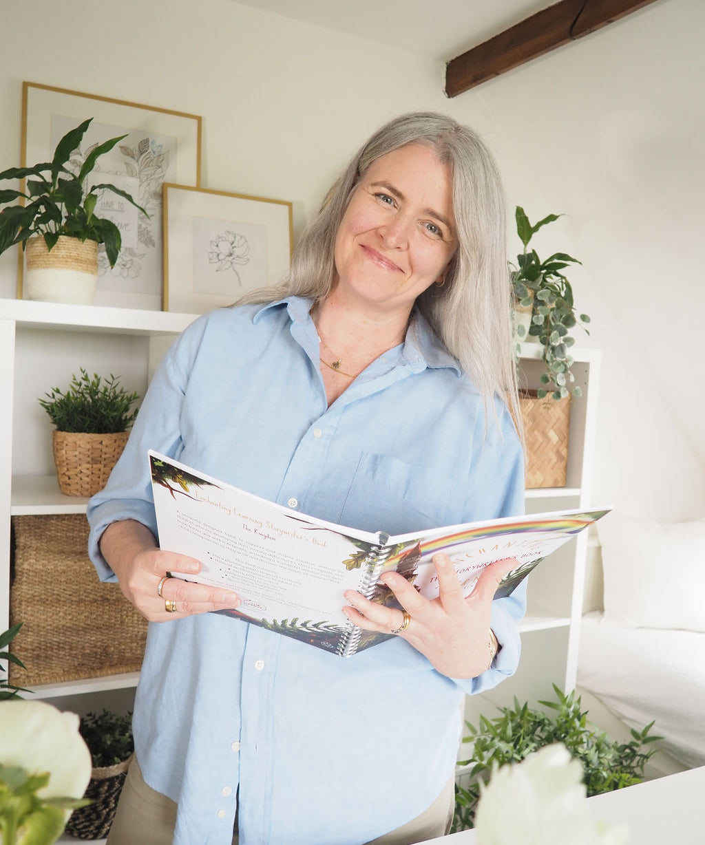 Woman smiling while holing story writing book.