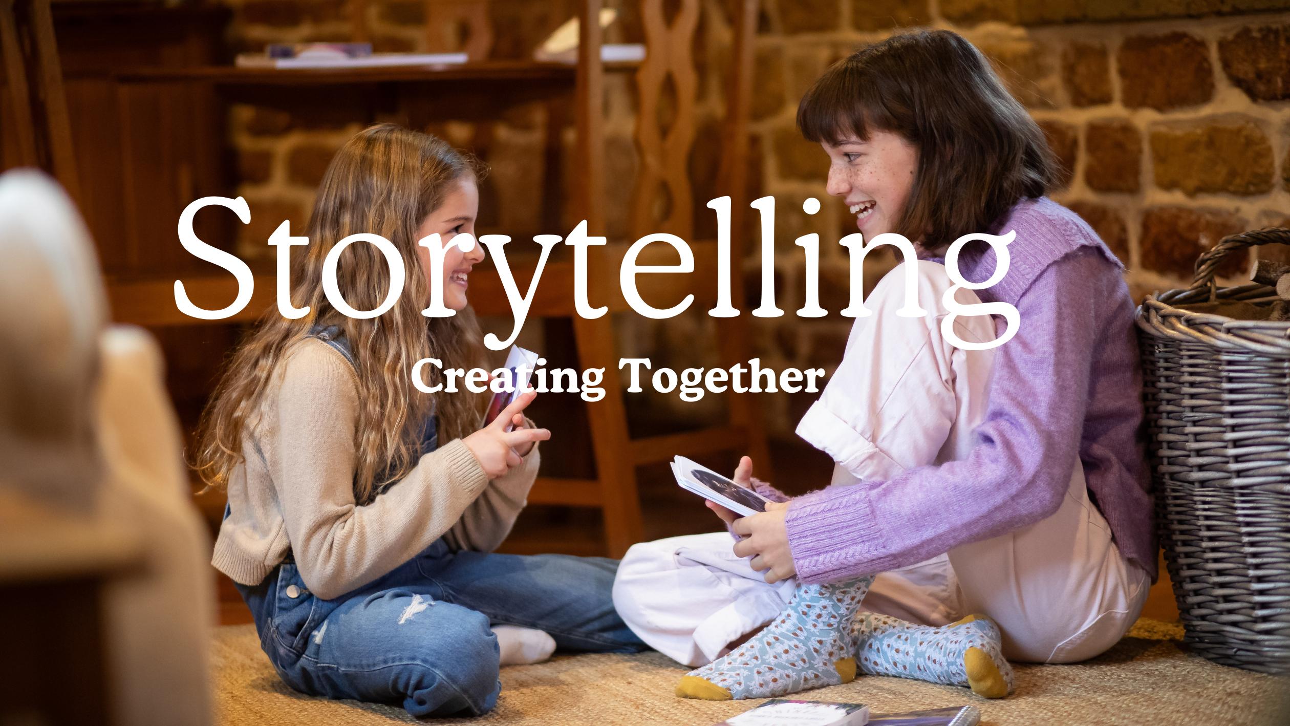 Two girls sat together telling a story using Ocean Story Creator Cards.