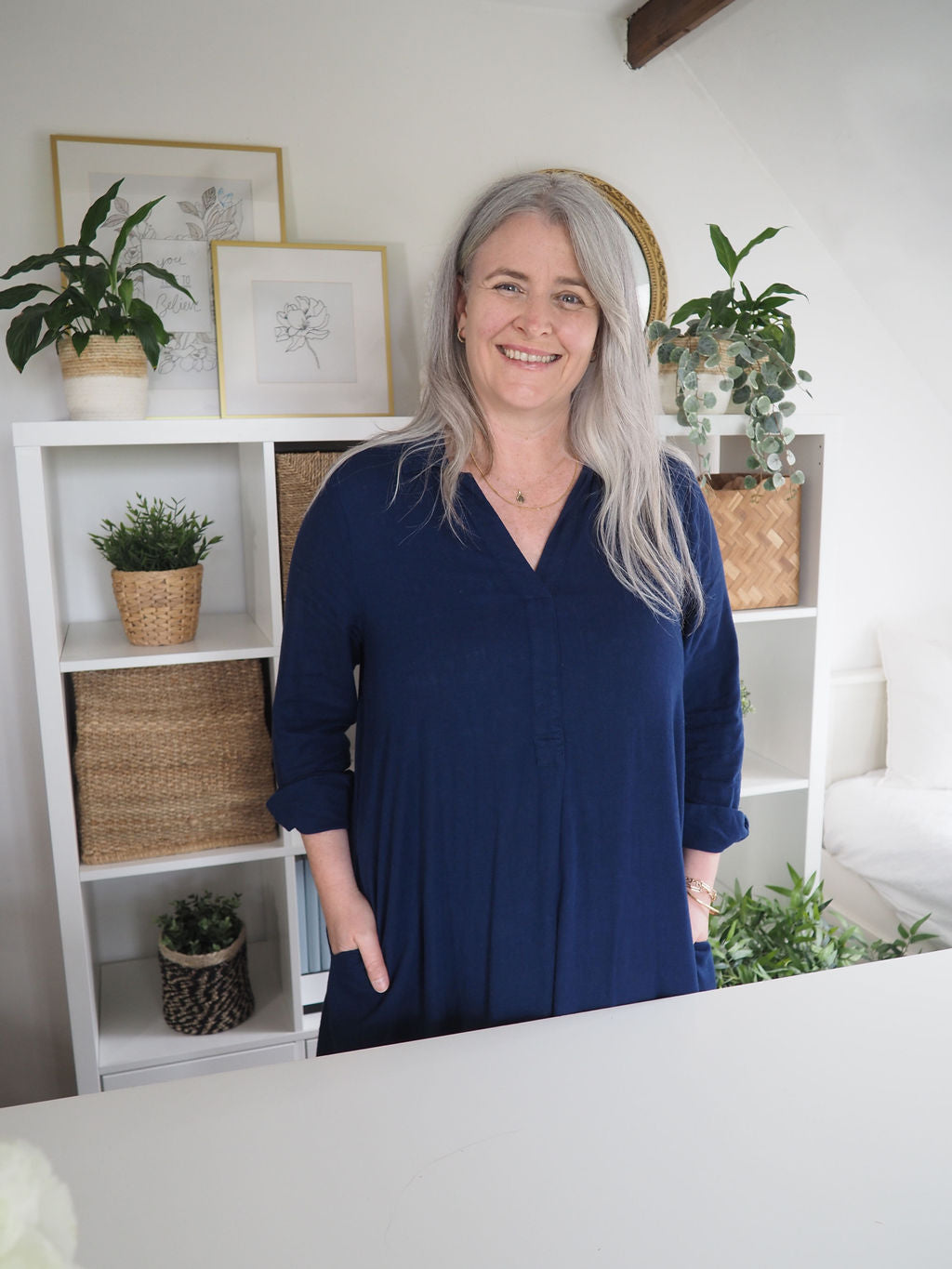 Founder of The Phive landing behind a desk smiling.