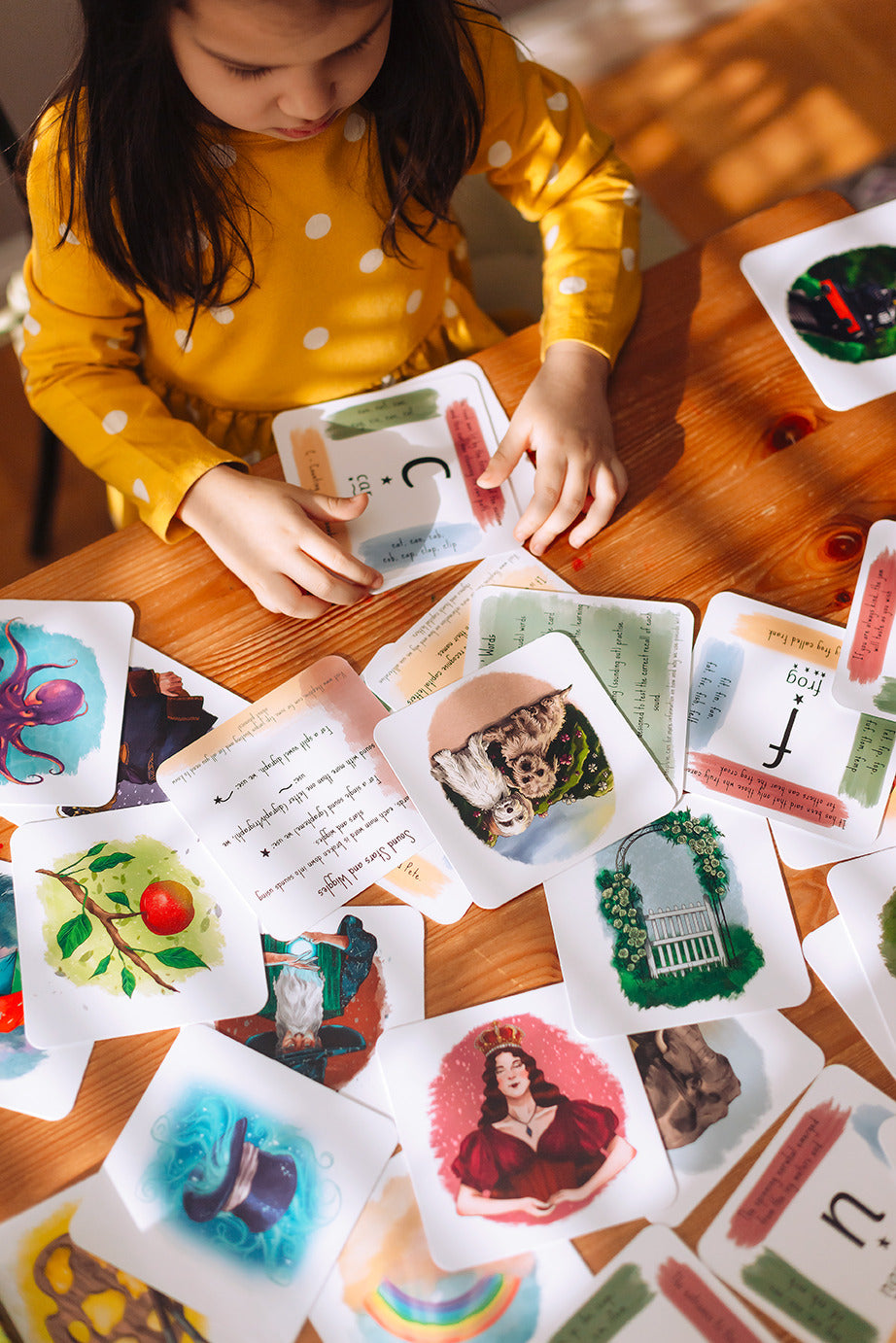 A girl sorting her phonics cards.