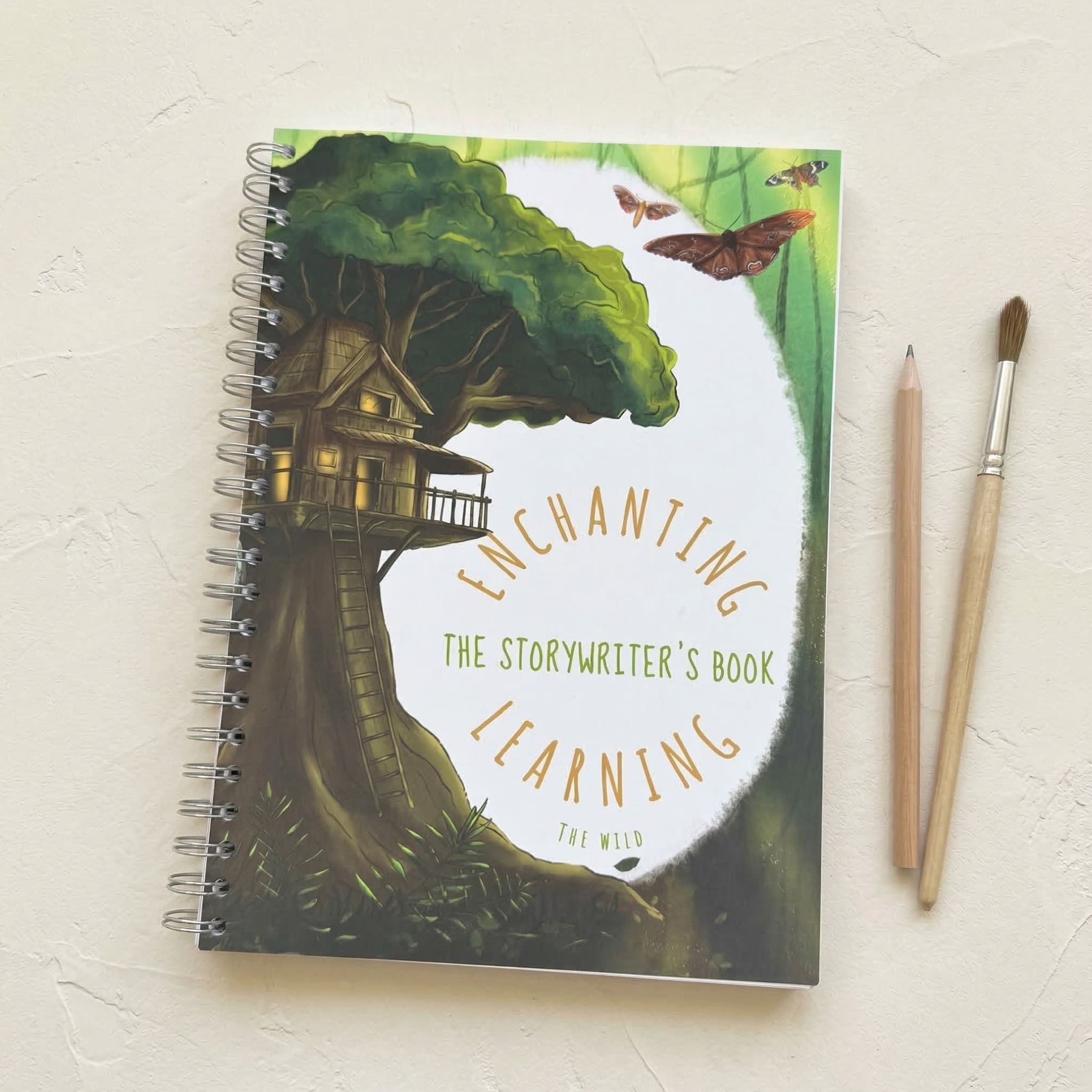 creative writing book with treehouse illustration and 'Enchanting Learning' text on a light background.