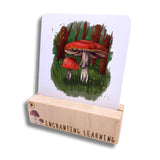 A wooden card block holding the mushroom card.