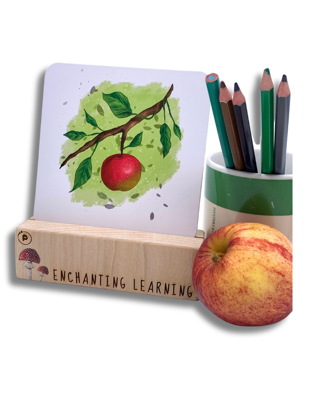 A phonics card showing an apple set in a wooden card stand.