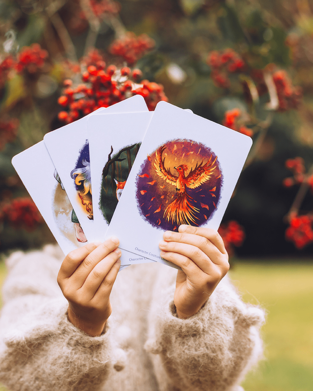 Girl in woods holding story writing cards showing phoenix .