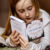 Child holding and reading 'Enchanting Story Creator Cards' book