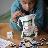 Child interacting with educational materials on a wooden table