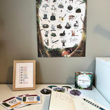 The woodland alphabet poster hanging above a desk with enchanting learning cards below.