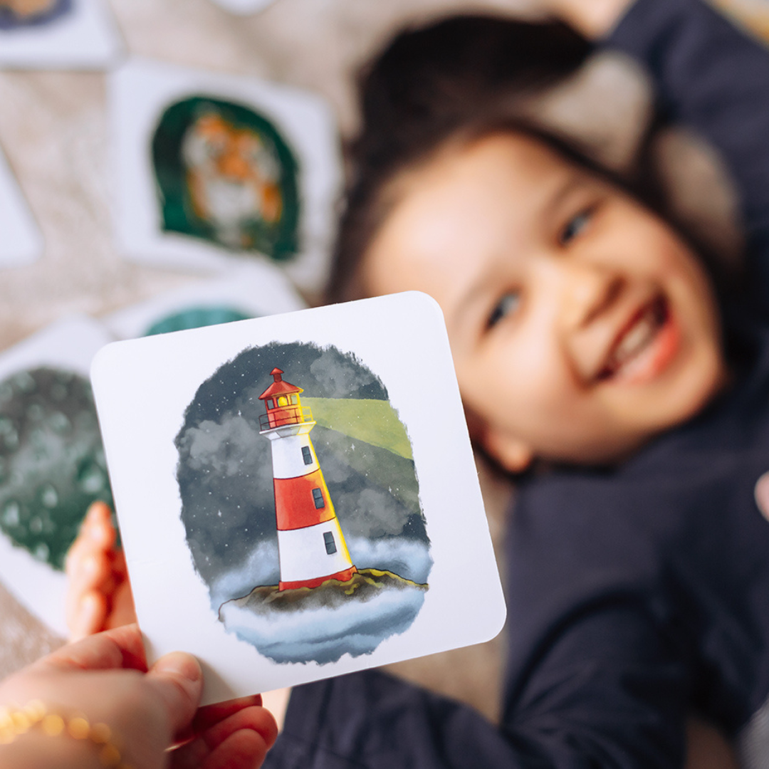 a girl holding a lighthouse card.
