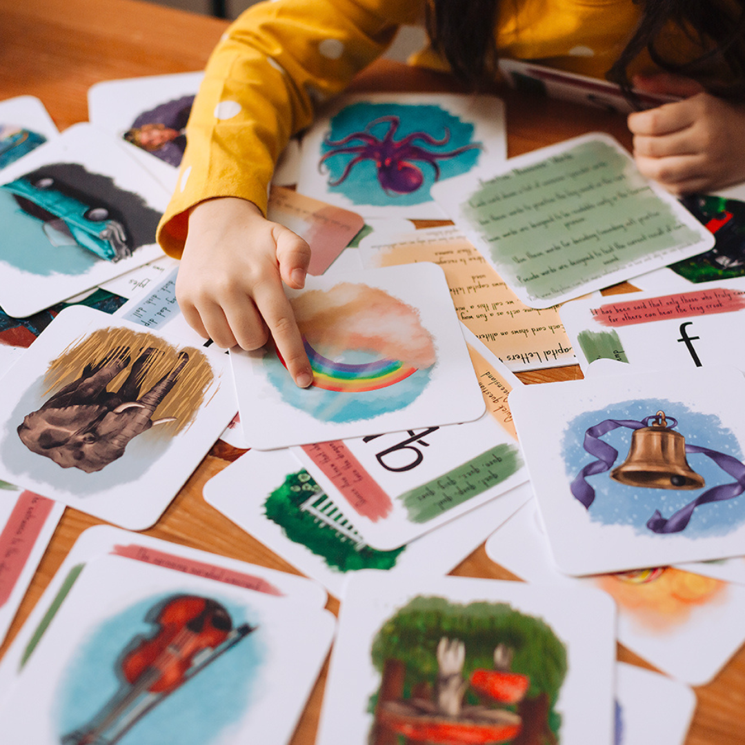 a child pointing to a rainbow card.