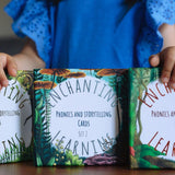 Girl in blue resting hands on three boxes of phonics and storytelling cards.