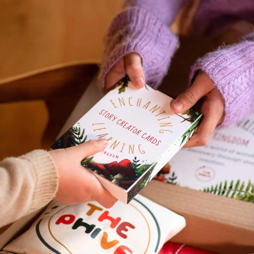 Two children holding a pack of Story Creator Cards for storytelling.