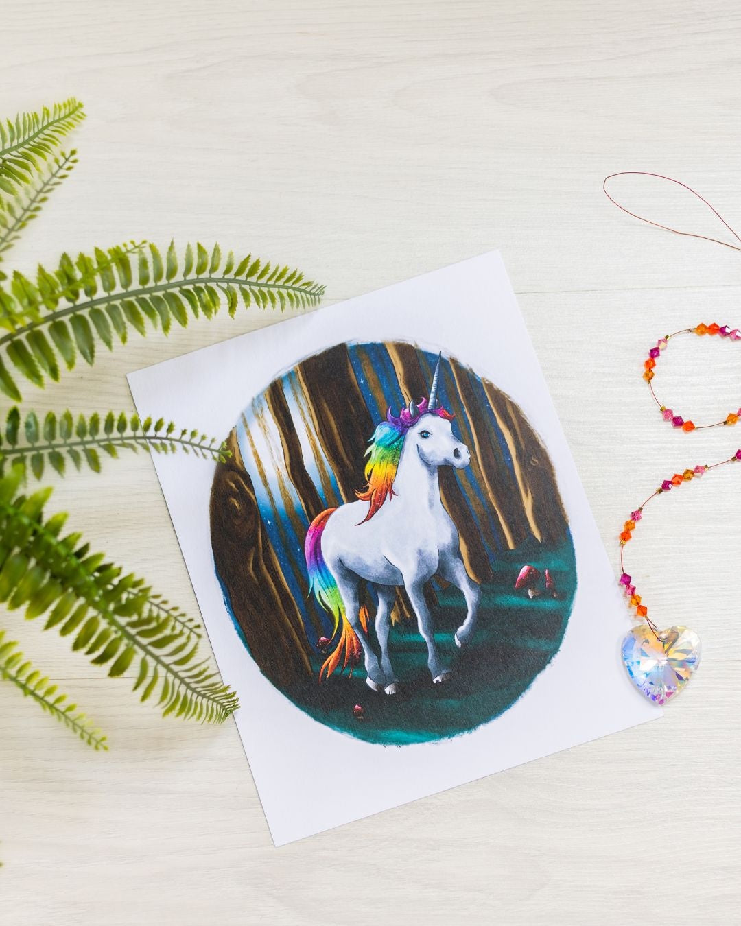 kids unicorn print on table with a crystal pendant.