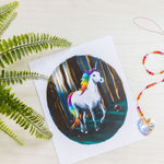 kids unicorn print on table with a crystal pendant.