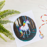 kids unicorn print on table with a crystal pendant.