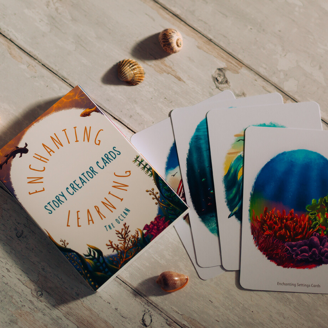 Card deck titled 'Enchanting Story Creator Cards' on a wooden surface with colorful cards featuring nature designs.