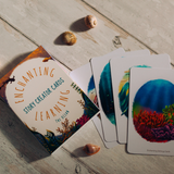 Card deck titled 'Enchanting Story Creator Cards' on a wooden surface with colorful cards featuring nature designs.