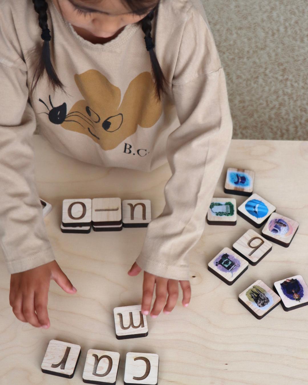 Girl playing with maple wood tiles.