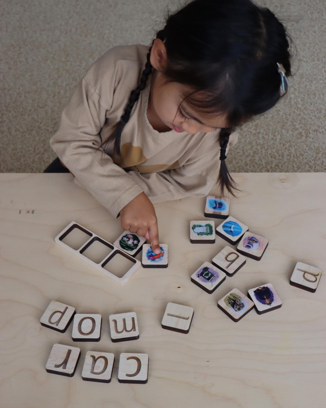 Child playing with phonic tiles.