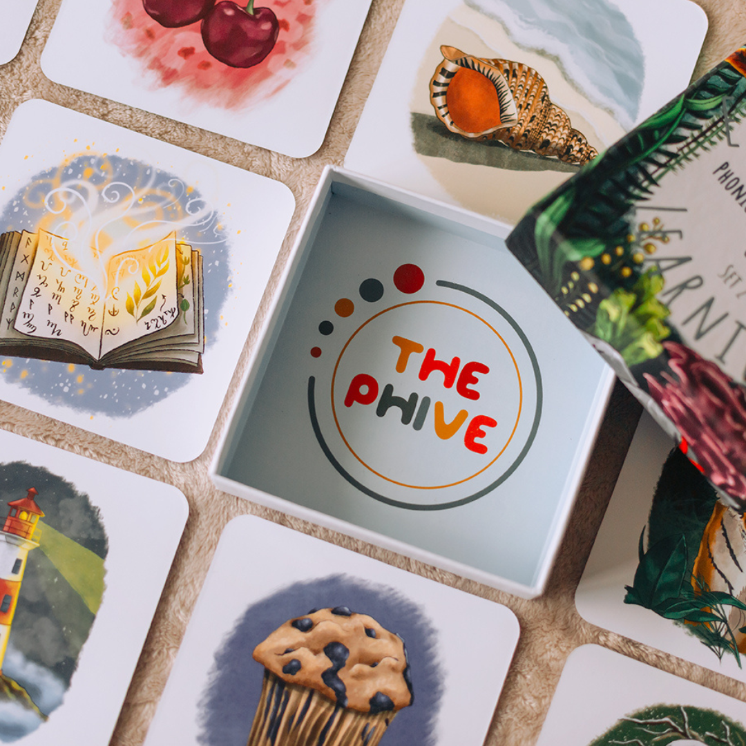 phonics tiles and packaging in a grid on the floor.