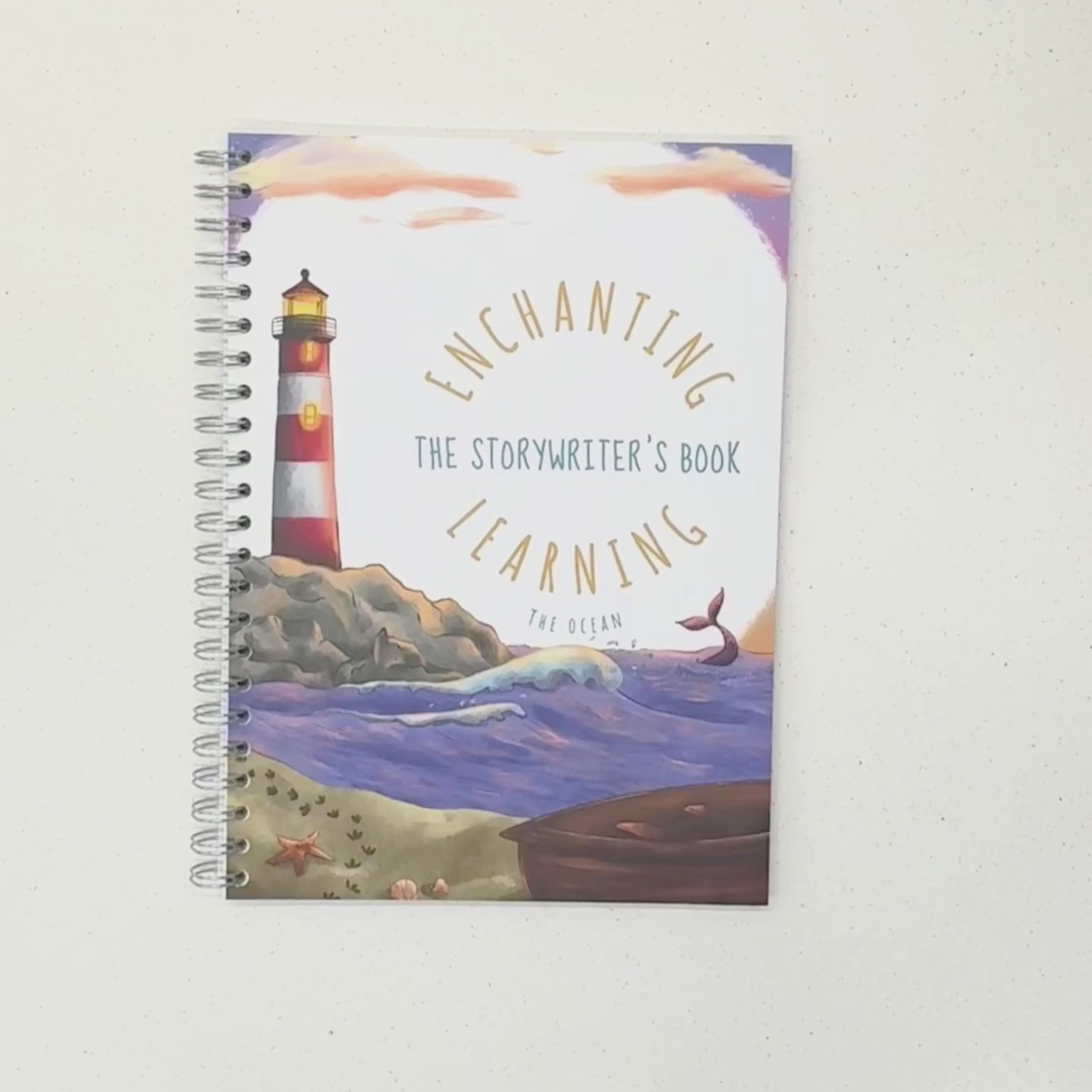 Ocean decorated book and card showing lighthouse and an underwater scene.
