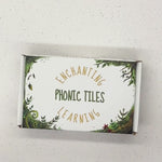 a white box with forest design containing 30 wooden phonics tiles made of maple wood