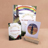 Educational materials including a book, cards, and a card holder showing a castle card on a beige background