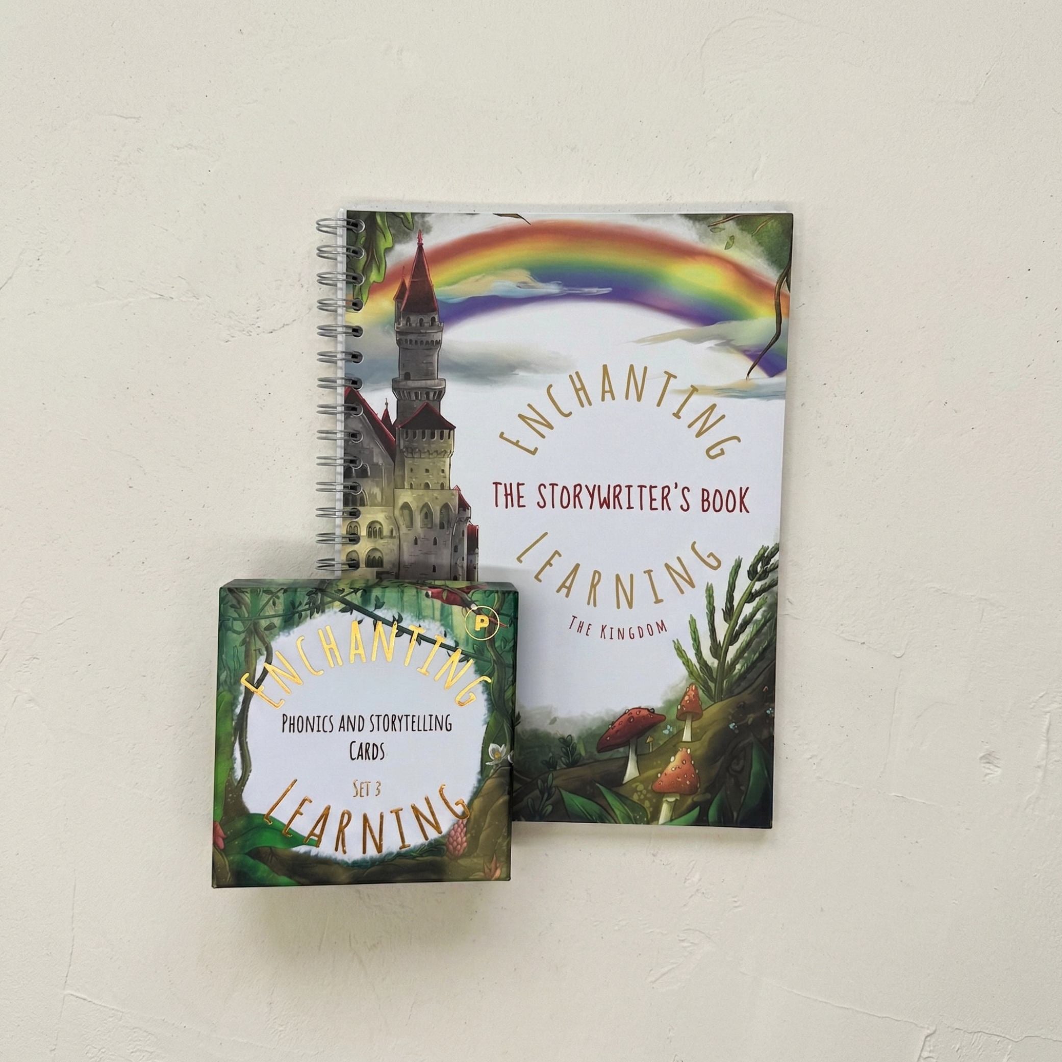 the kingdom writing book with a castle on the front with a set of jungle themed phonics cards.