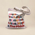 Tote bag with colorful text on a beige background
