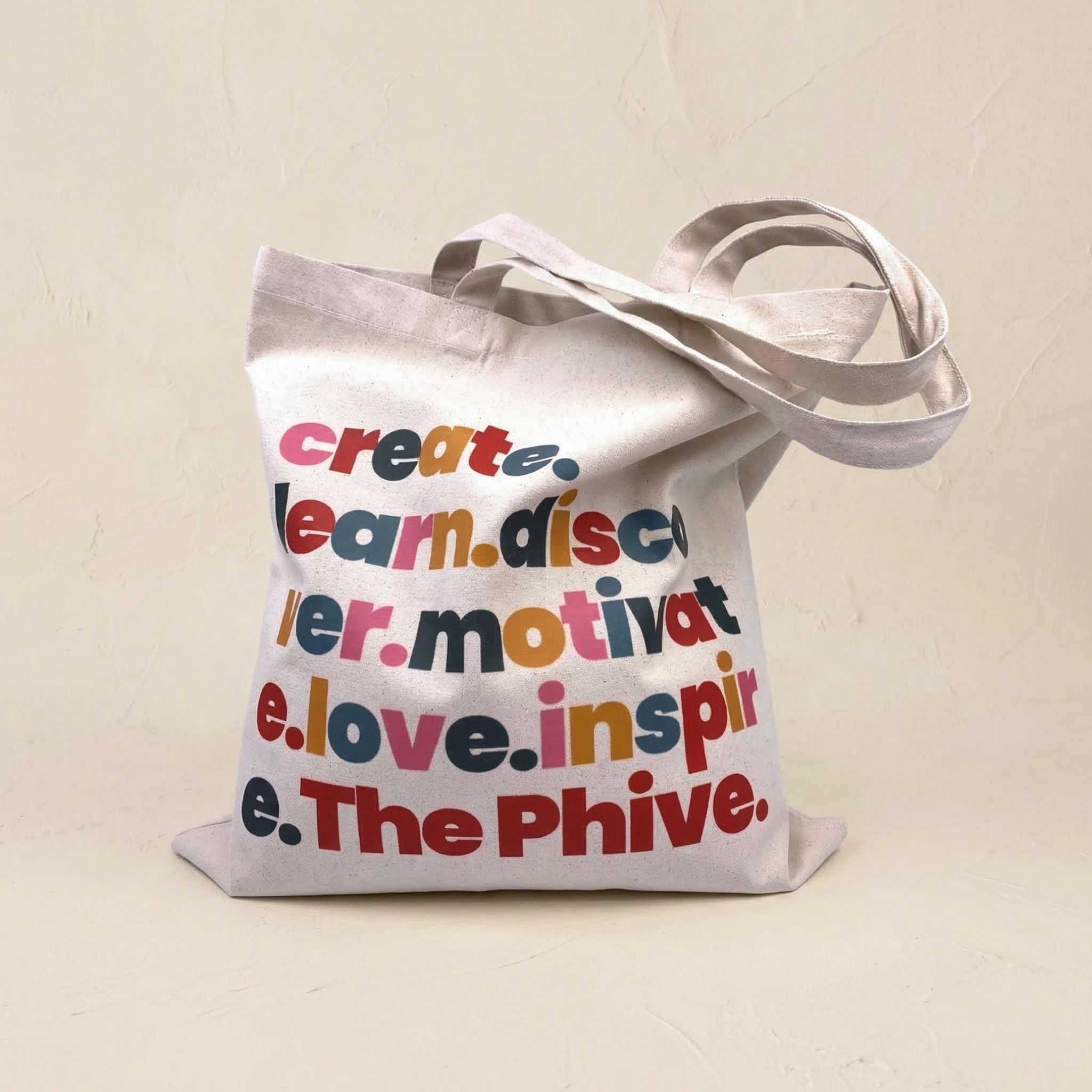 Tote bag with colorful text on a beige background