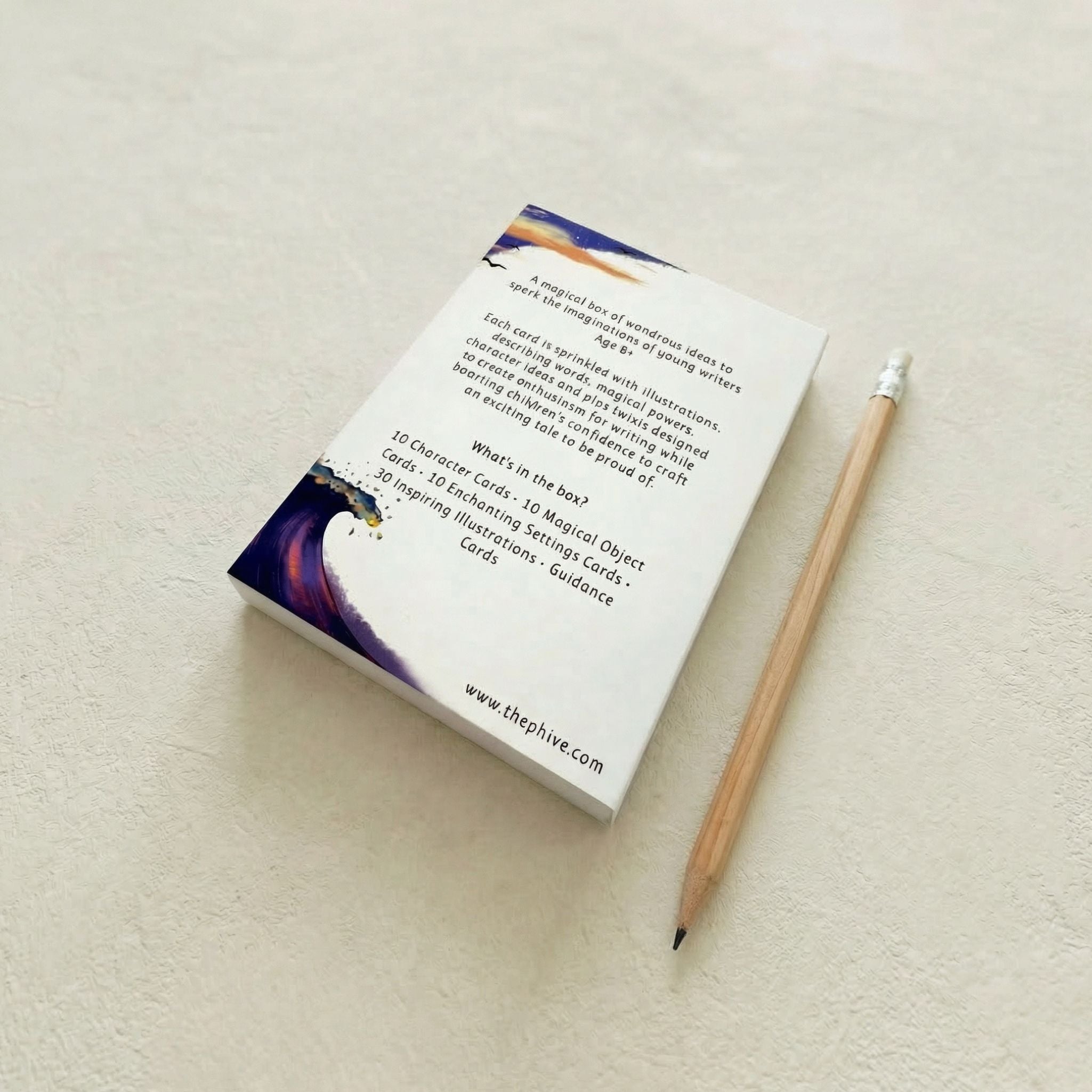 back view of story creator cards, in an ocean theme with a pencil on a light surface