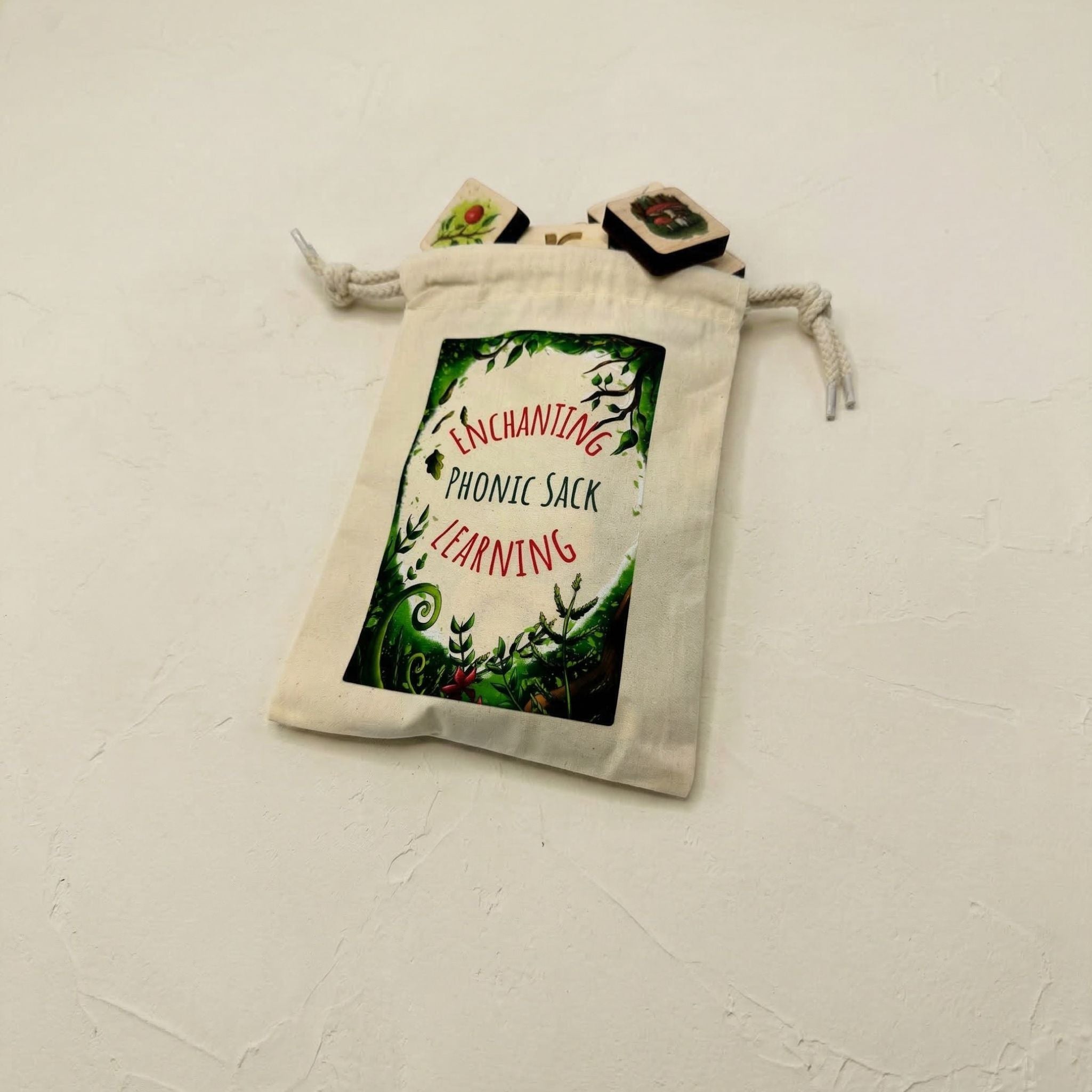 White drawstring pouch for phonics games with text and graphics on a light gray background