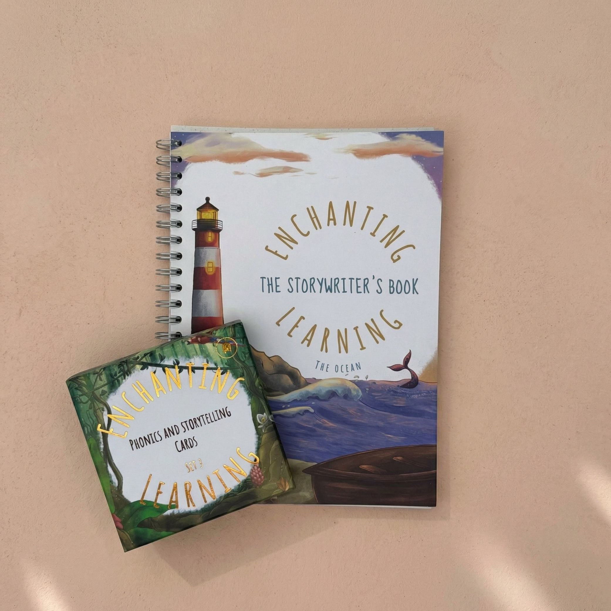 An ocean themed writing book with a lighthouse with a set of jungle themed phonics cards.