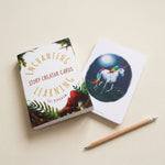 Card with unicorn illustration and 'Enchanting Story Creator Cards' packaging on a beige background