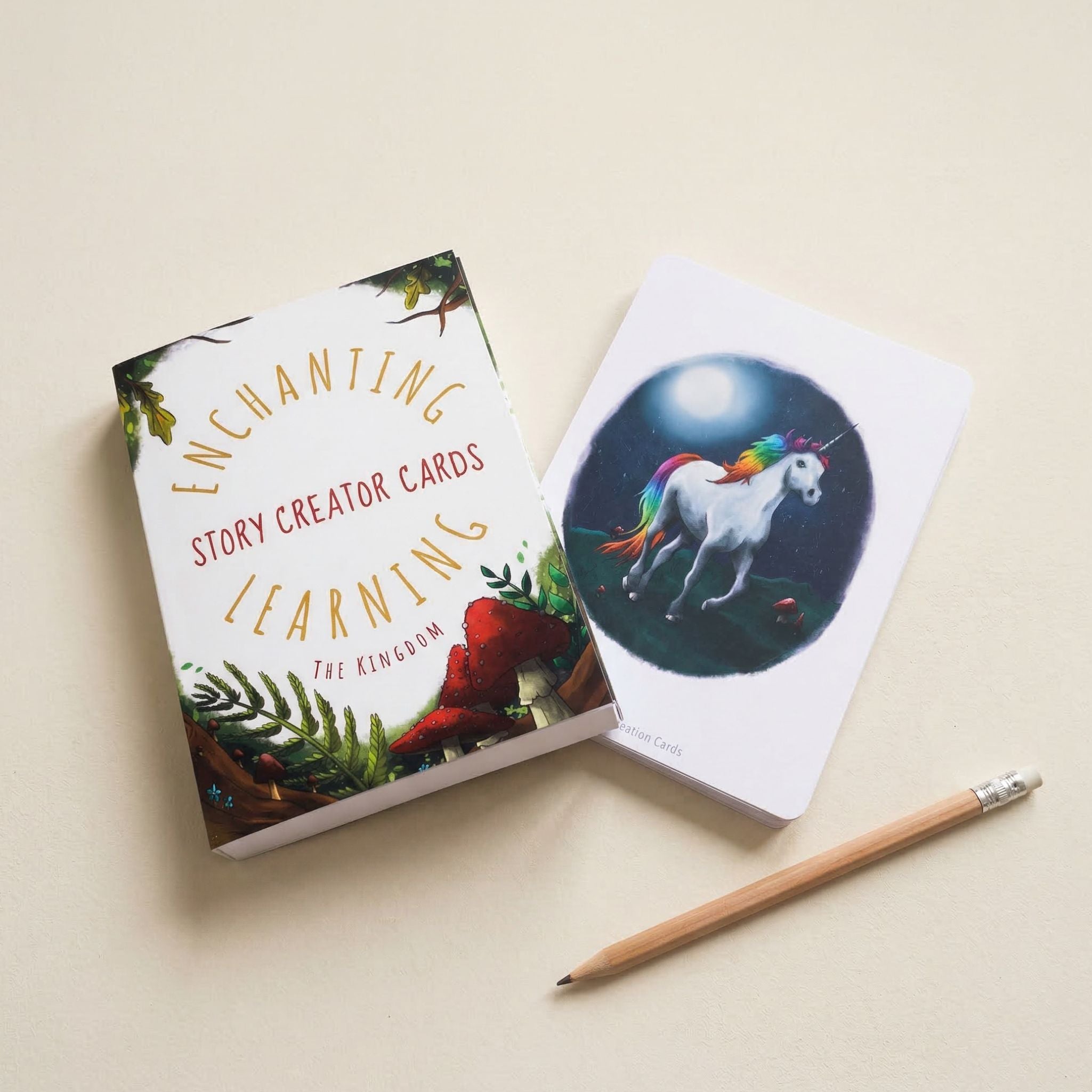 Card with unicorn illustration and 'Enchanting Story Creator Cards' packaging on a beige background