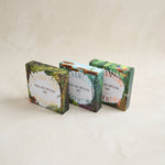 Three boxes of phonics and storytelling cards on a light beige background