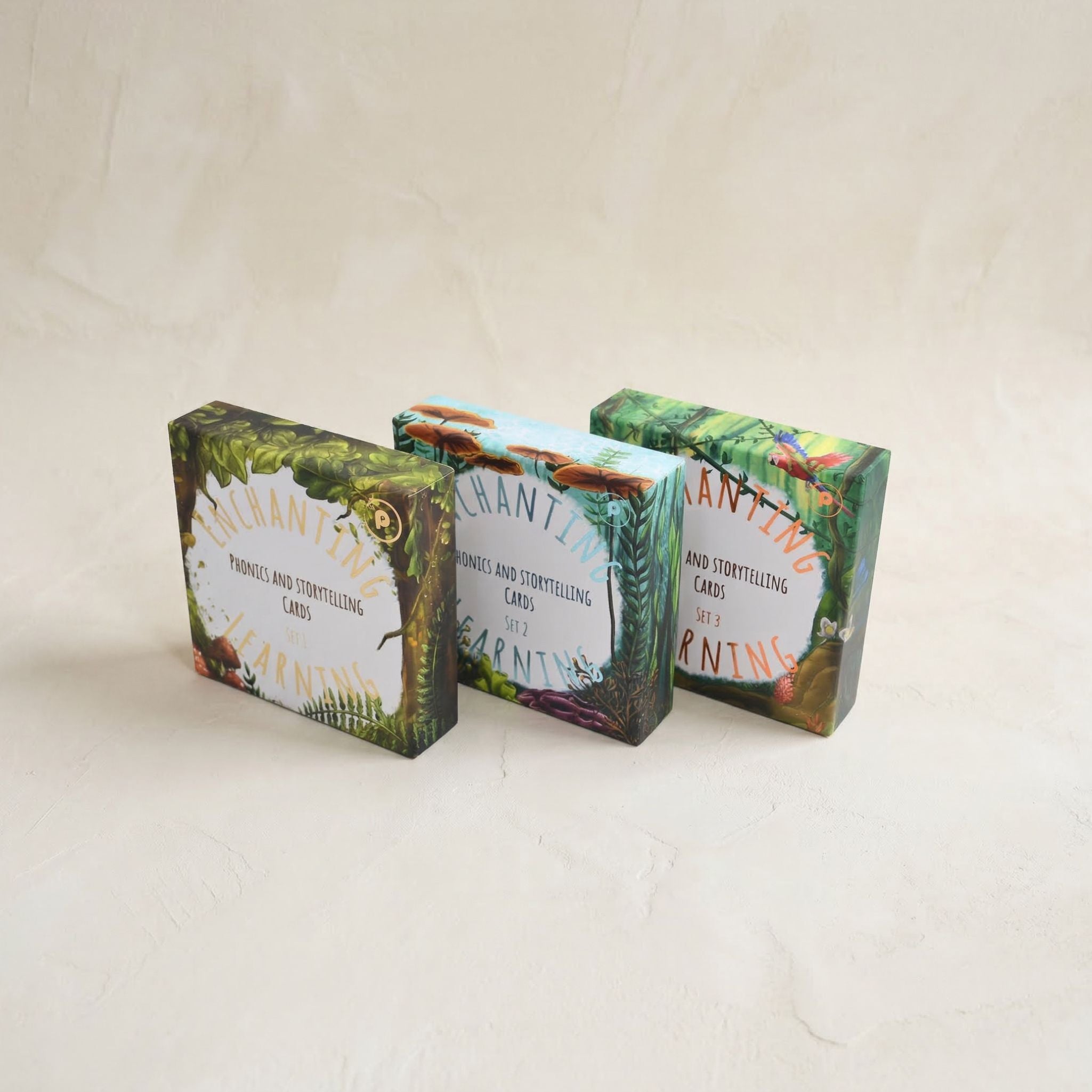 Three boxes of phonics and storytelling cards on a light beige background