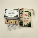 box of wooden phonic tiles with wooden word frames, a card with words to make and a cream play sack with a forest scene.