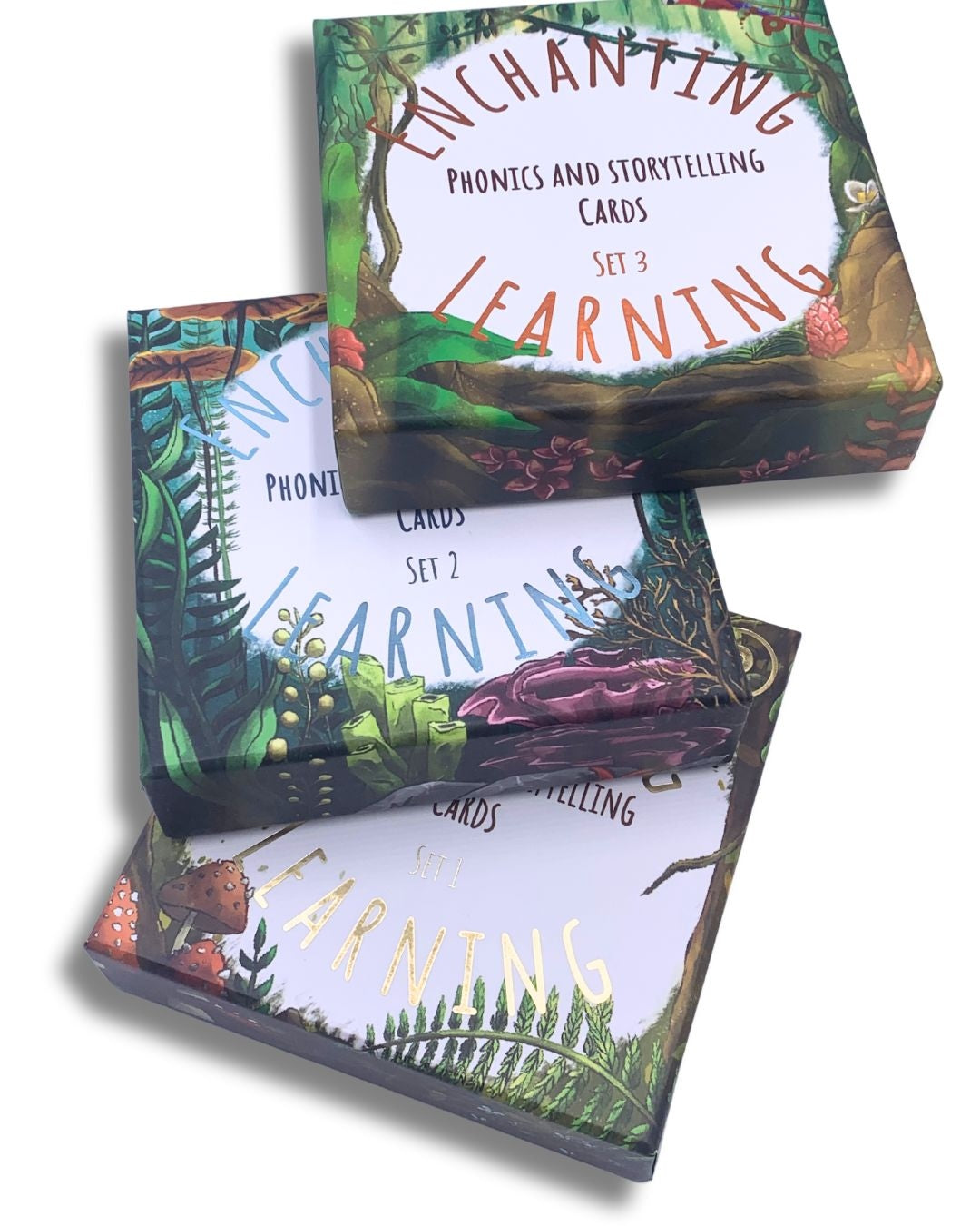 Three sets of phonics and storytelling cards stacked up showing box designs.