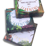 Three sets of phonics and storytelling cards stacked up showing box designs.