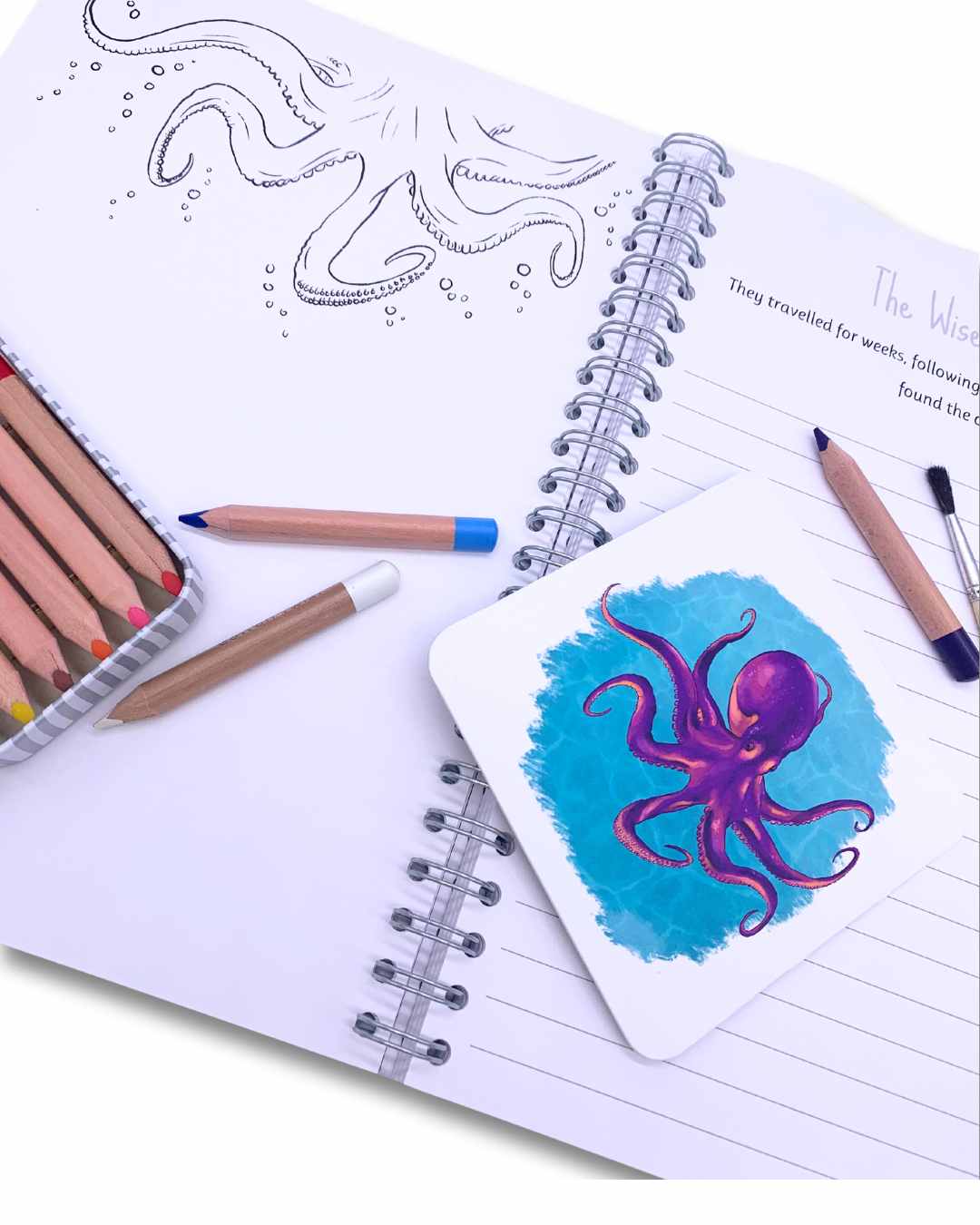 Writing book open at illustration page showing octopus phonics card.