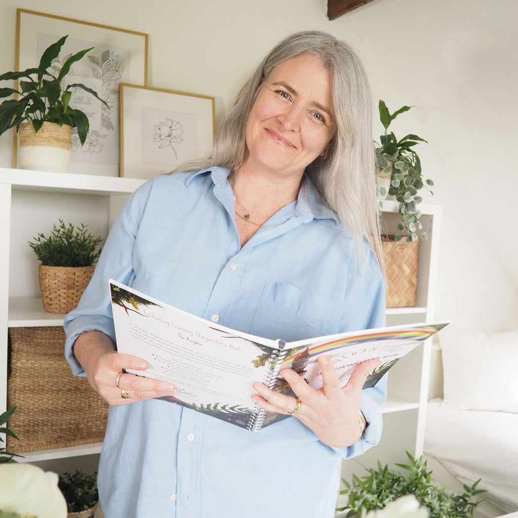 Woman smiling while holing story writing book.